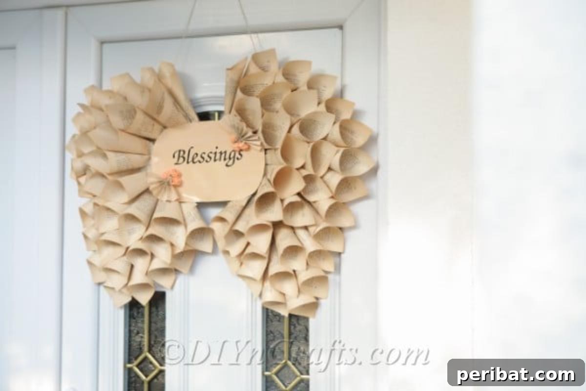 Literary Angel Wings Decor 5 Finished book page angel wings decoration adorning a door, showcasing its full size and elegant design.