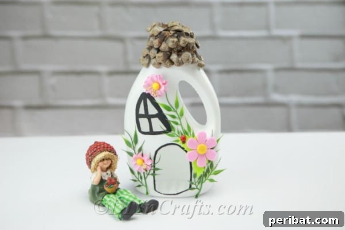Fairy house with a fairy sitting next to it, crafted from an upcycled laundry detergent bottle