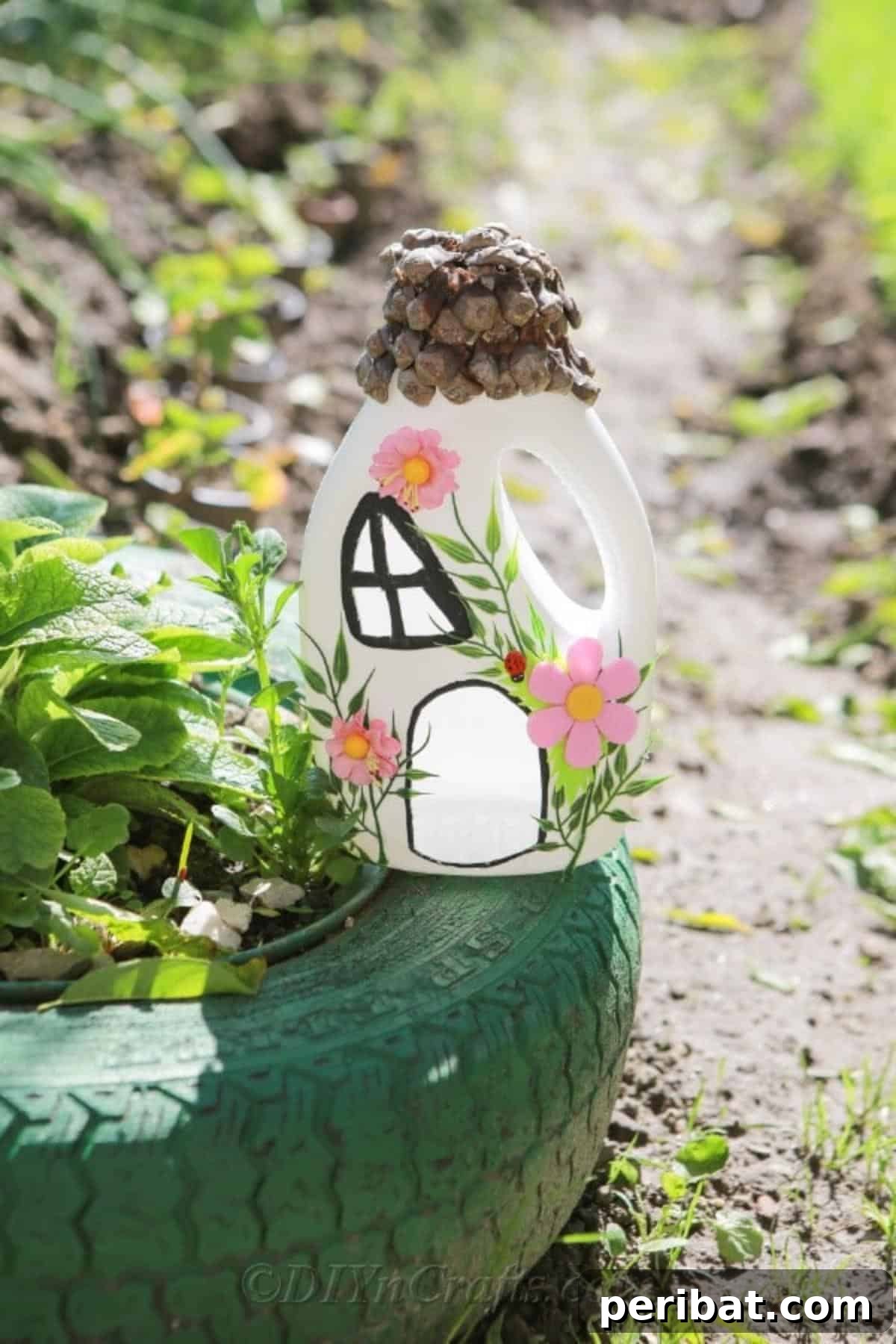 Upcycled fairy house sitting creatively on a green tire in a garden setting, surrounded by lush plants