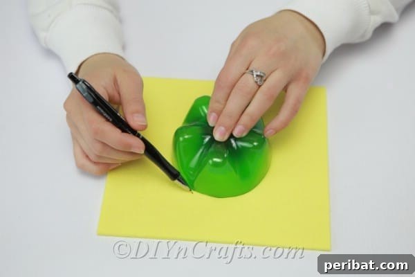 Tracing the bottom of a soda bottle onto yellow craft foam to create the turtle's body outline.