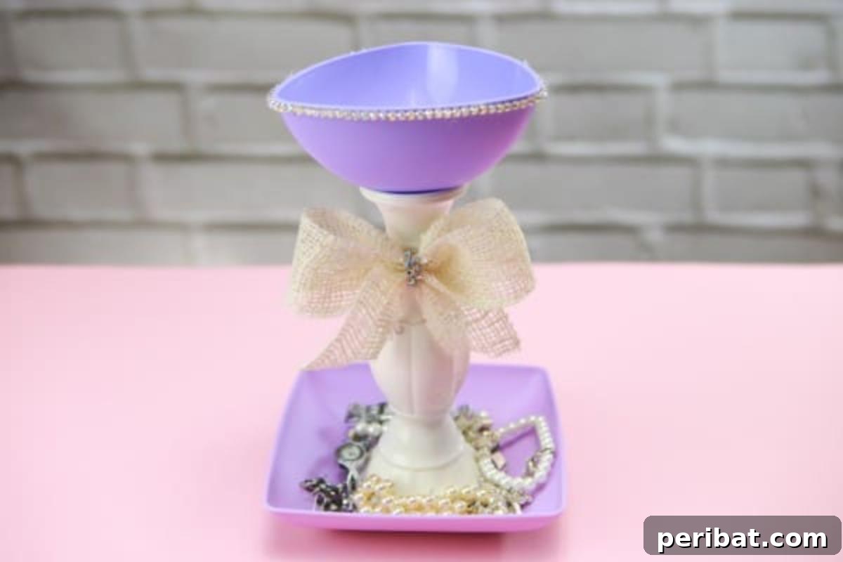 Upcycle Plates into a Stylish Two-Tier Jewelry Holder 3 Purple jewelry stand with various jewelry pieces in the bottom plate