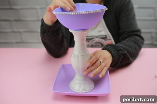 Upcycle Plates into a Stylish Two-Tier Jewelry Holder 6 Purple plates with a white candlestick positioned between them
