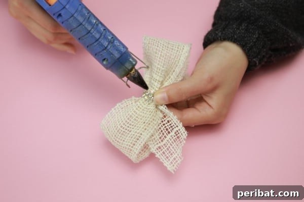 Upcycle Plates into a Stylish Two-Tier Jewelry Holder 8 Making a bow from burlap with a hot glue gun