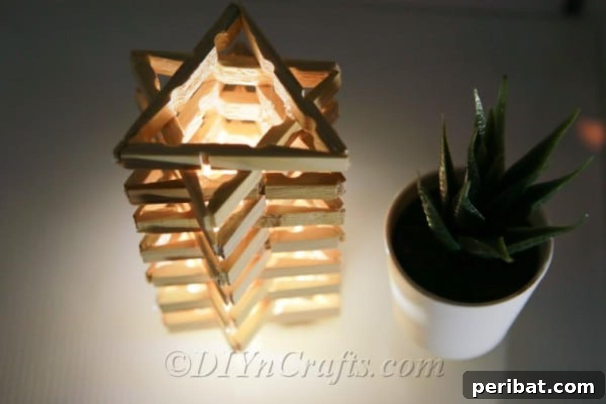 Transform Clothespins into a Stylish Lamp 2 Top view of star shaped clothespin lamp, casting intricate shadows.