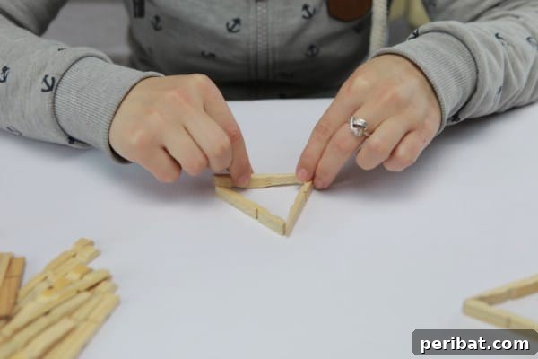 Forming a triangular base with three clothespin halves