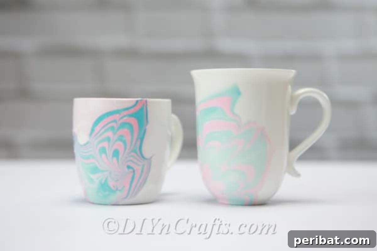 Nail Polish Marble Cup Magic 2 Two vibrant marbled coffee cups, showcasing unique designs created with nail polish.