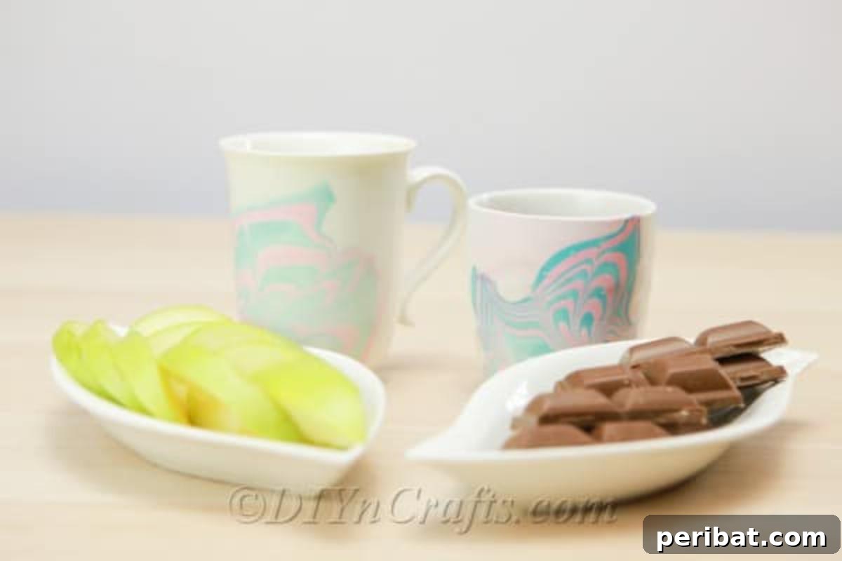 Nail Polish Marble Cup Magic 5 Beautifully marbled coffee cups arranged beside delicious snacks, ready for an enjoyable break.
