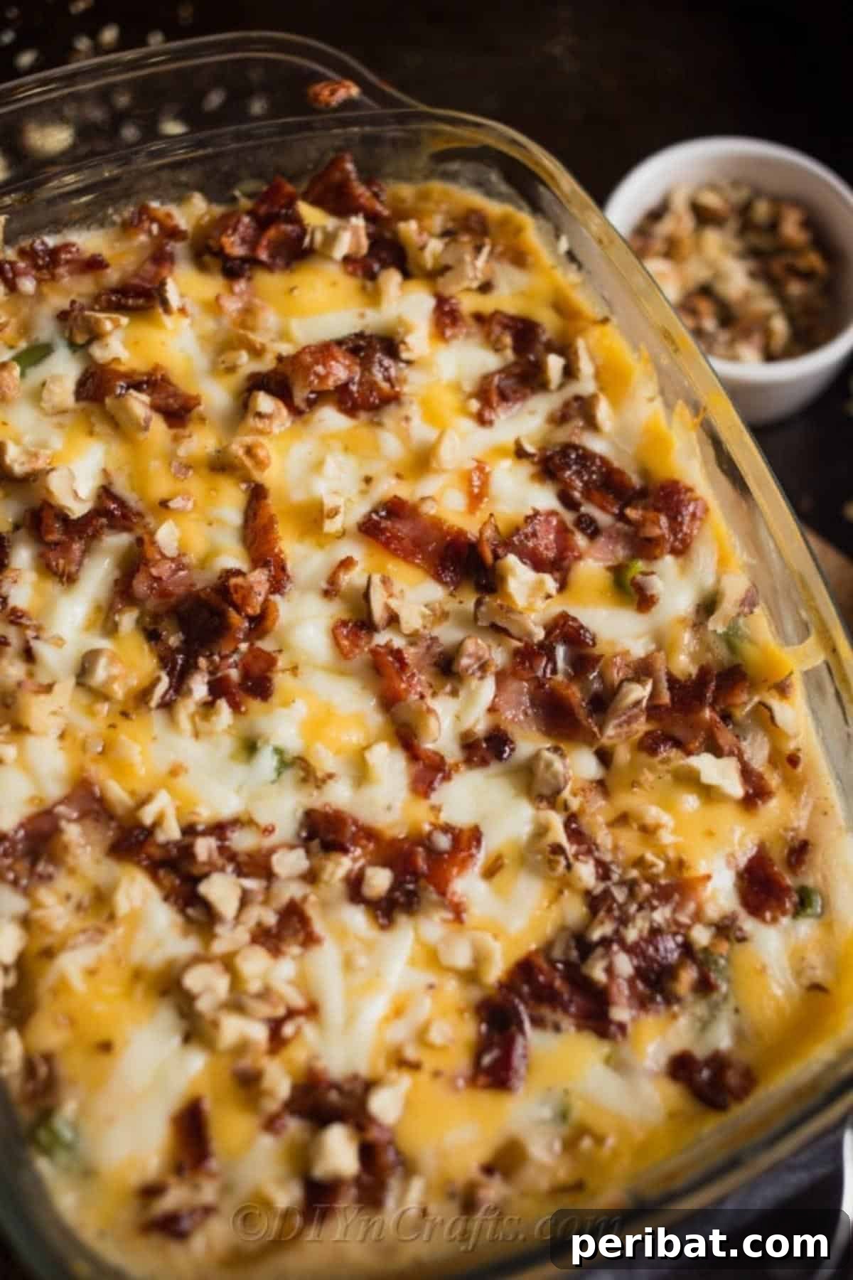 Irresistible Green Bean Casserole 4 Green bean casserole topped with melted cheese and chopped pecans, ready to be served