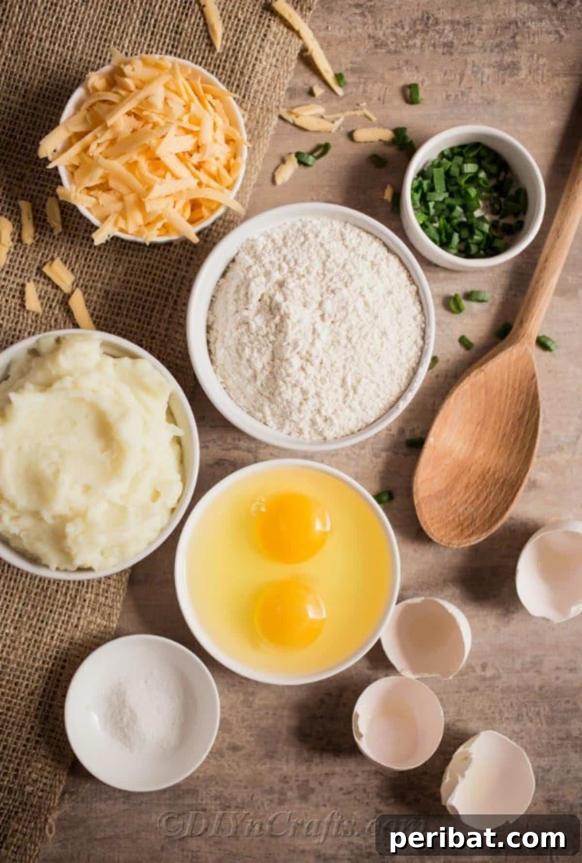 Effortless Potato Pierogi Delight 3 A selection of fresh ingredients laid out, including flour, eggs, sour cream, mashed potatoes, scallions, and shredded cheese, ready for making homemade potato pierogies.