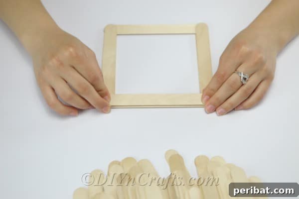 Continue stacking craft sticks, aligning them with the previous layer.