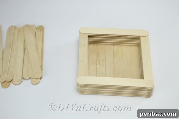 The completed floor of the craft stick bird feeder.
