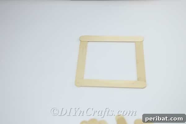 First step: Create a square base using two parallel and two perpendicular craft sticks.