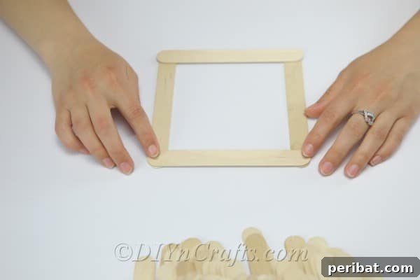 The initial square structure of the craft stick bird feeder.