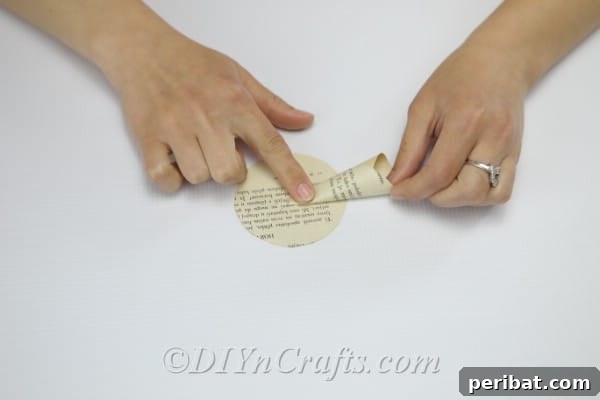 Literary Blooms: Crafting Flowers from Old Book Pages 13 Start gluing petals onto your flower.