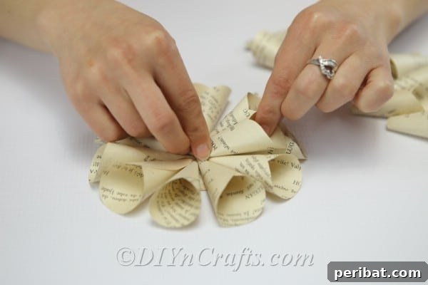 Literary Blooms: Crafting Flowers from Old Book Pages 15 Start making your second layer of petals.