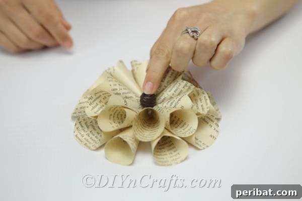 Literary Blooms: Crafting Flowers from Old Book Pages 18 Glue a bead in the center of the flower.
