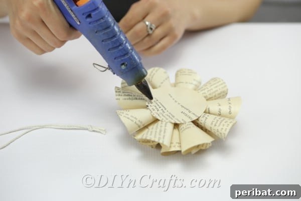 Literary Blooms: Crafting Flowers from Old Book Pages 19 Apply glue to the back of the flower.