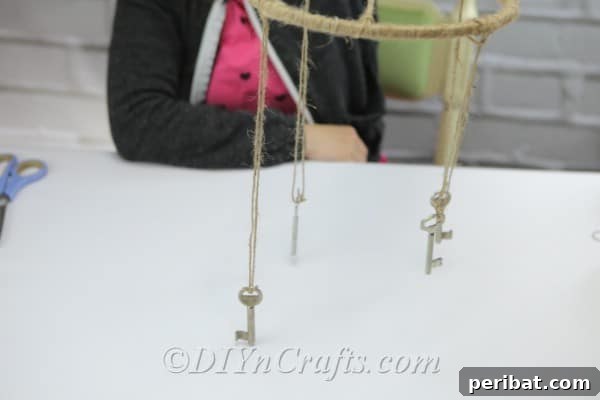 Crafting Your Own Rustic Wind Chime 14 Hang keys from strands of twine from the hoop.