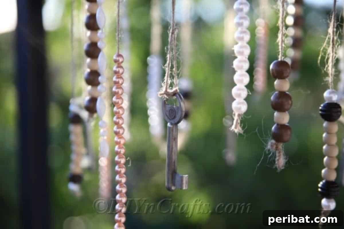 Crafting Your Own Rustic Wind Chime 20 DIY wind chimes bring joy to any space. A close-up of the finished rustic wind chime with blurred greenery in the background, suggesting an outdoor setting.
