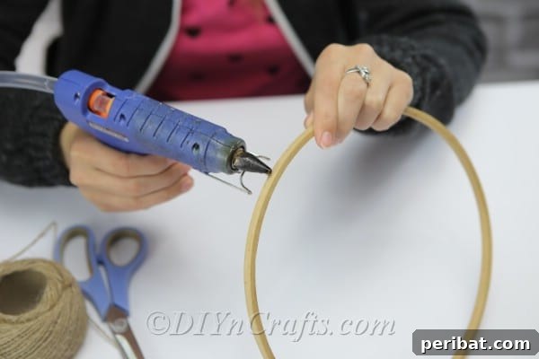 Crafting Your Own Rustic Wind Chime 5 Apply glue to the wooden hoop.