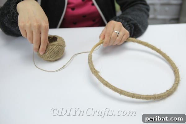 Crafting Your Own Rustic Wind Chime 7 Continue winding the twine around the wooden hoop.