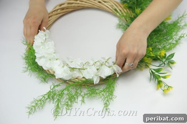 Attach some greenery to the top of the wreath.