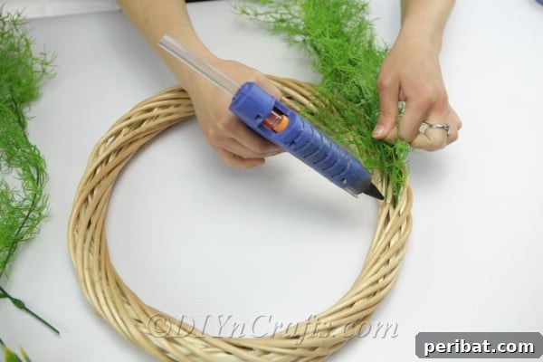 Glue branches to the wreath.