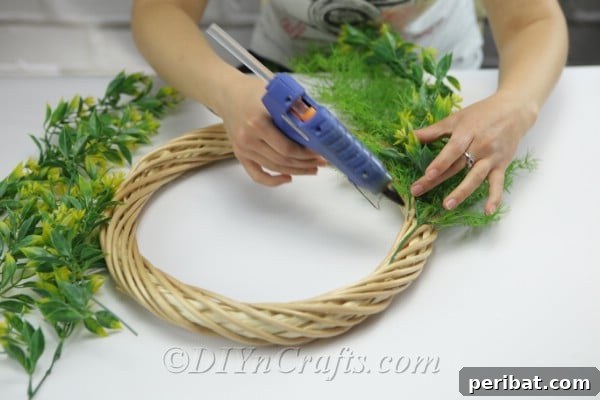 Glue more branches to the wreath.