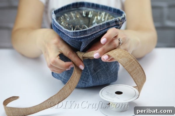 Blooming Denim Art 10 Tie rustic ribbon around the neck of the denim-covered vase to add decorative flair.