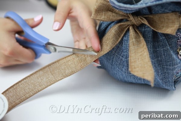 Blooming Denim Art 11 Trim the ends of the rustic ribbon after tying a bow on the vase.