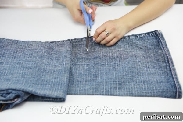 Measure and cut the pant leg to fit your vase, allowing extra for sealing.