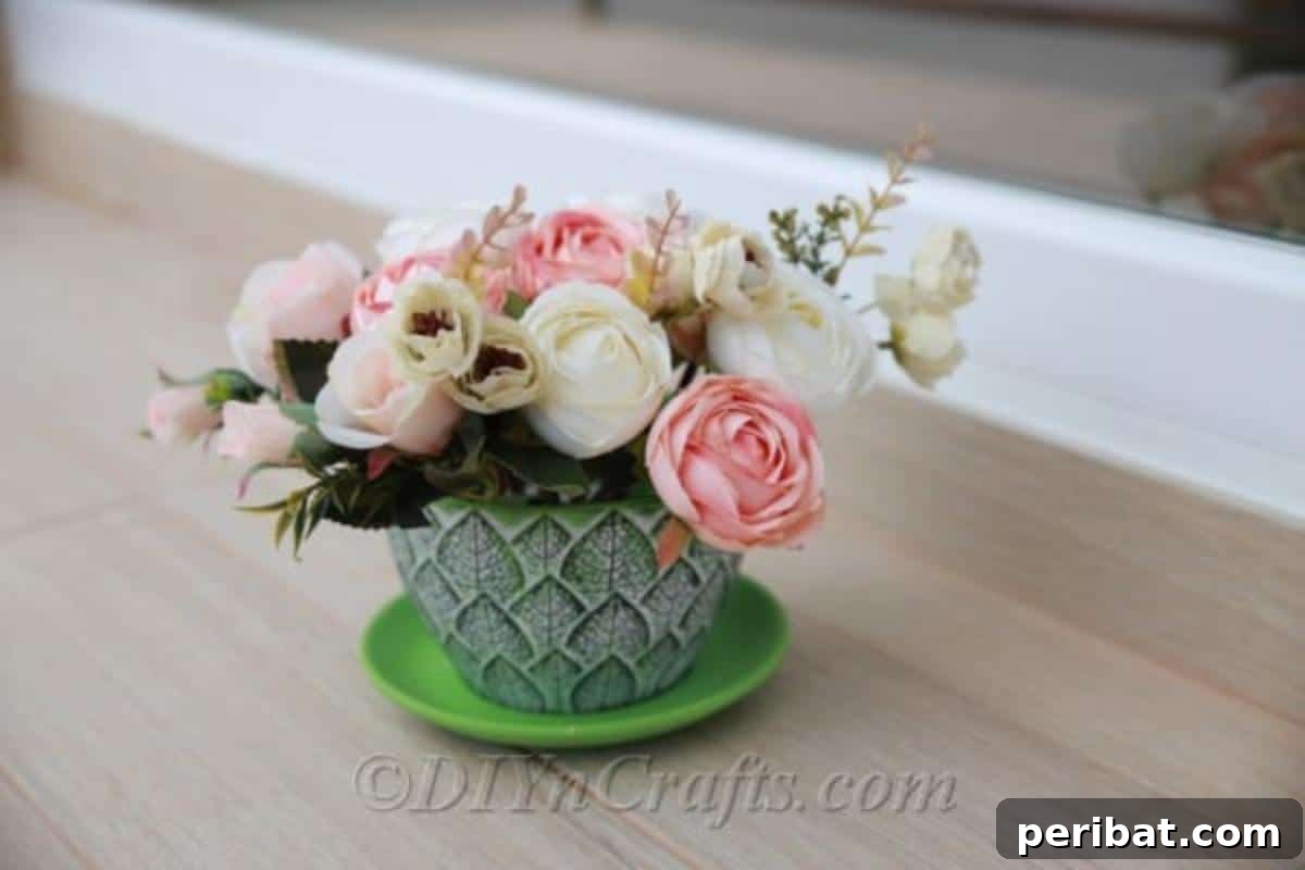 Floral Magic in a Teacup 2 Outdoor setting featuring a charming teacup floral display on a garden table, brimming with colorful flowers.