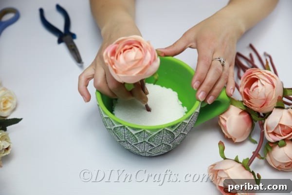 Floral Magic in a Teacup 13 Begin arranging flowers inside the teacup, pushing stems into the Styrofoam for stability.