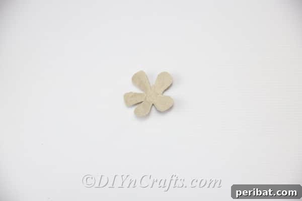 Refine the edges of your five petals, trimming them carefully with scissors to give them a natural, soft curve.