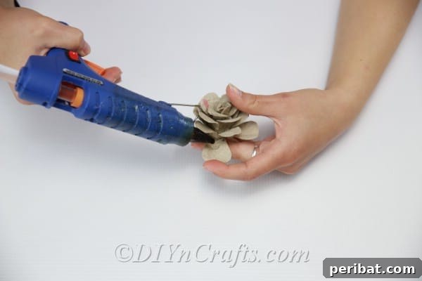 Keep gluing on additional layers of petals, progressively working outwards and shaping them for a realistic effect.