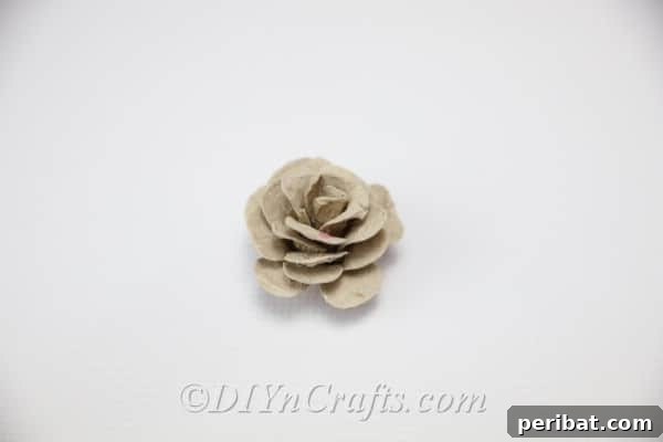 You have successfully created a rose from an egg carton, ready for its final touch of color.
