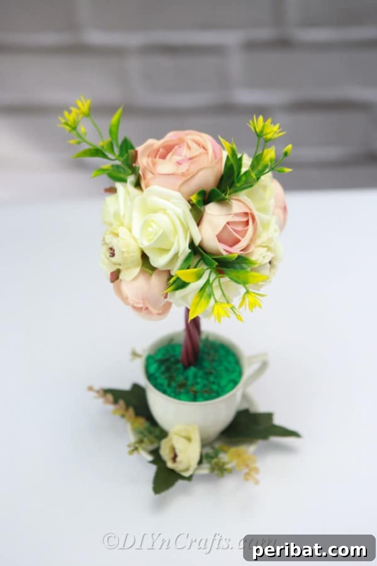 Learn to easily make a beautiful topiary tree flower arrangement for your home decor.