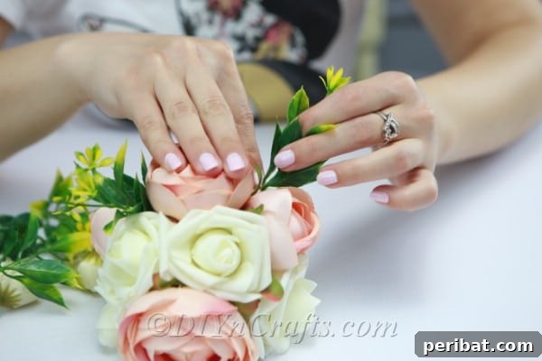 Insert the sprigs into the floral sphere between the flowers to add natural texture.