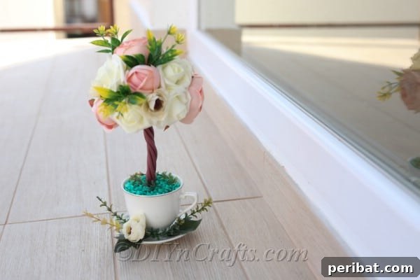 A topiary tree flower arrangement looks beautiful and complete when finished.