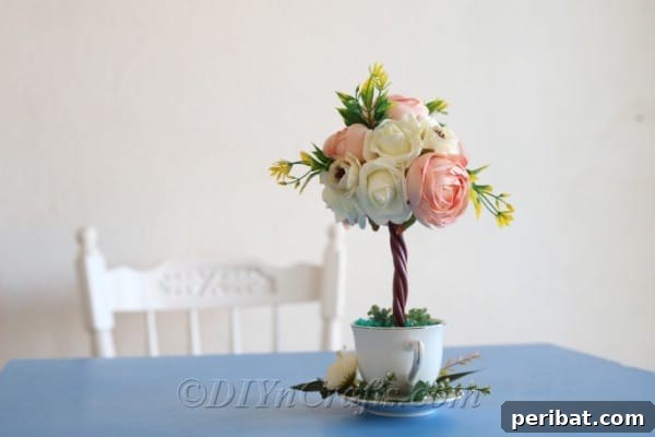 Your stunning topiary tree flower arrangement looks lovely on display as home decor.