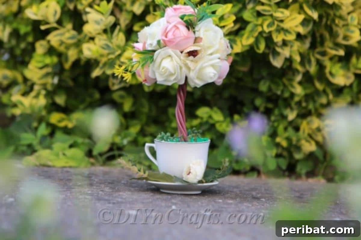 Your topiary tree flower arrangement is a perfect elegant decoration for any home or event setting.