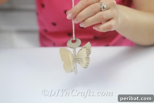 A rustic butterfly decoration, complete with key and twine, is now ready to hang and display.