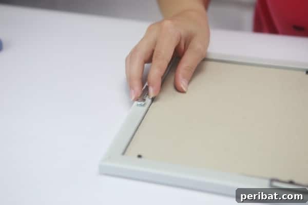 Reattach and firmly secure the original backing to the picture frame.