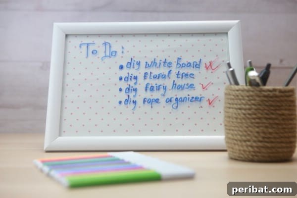 Build a Custom Whiteboard for Your Office 12 A decorative whiteboard sits on a desk with colorful markers, ready for notes and creative expressions.