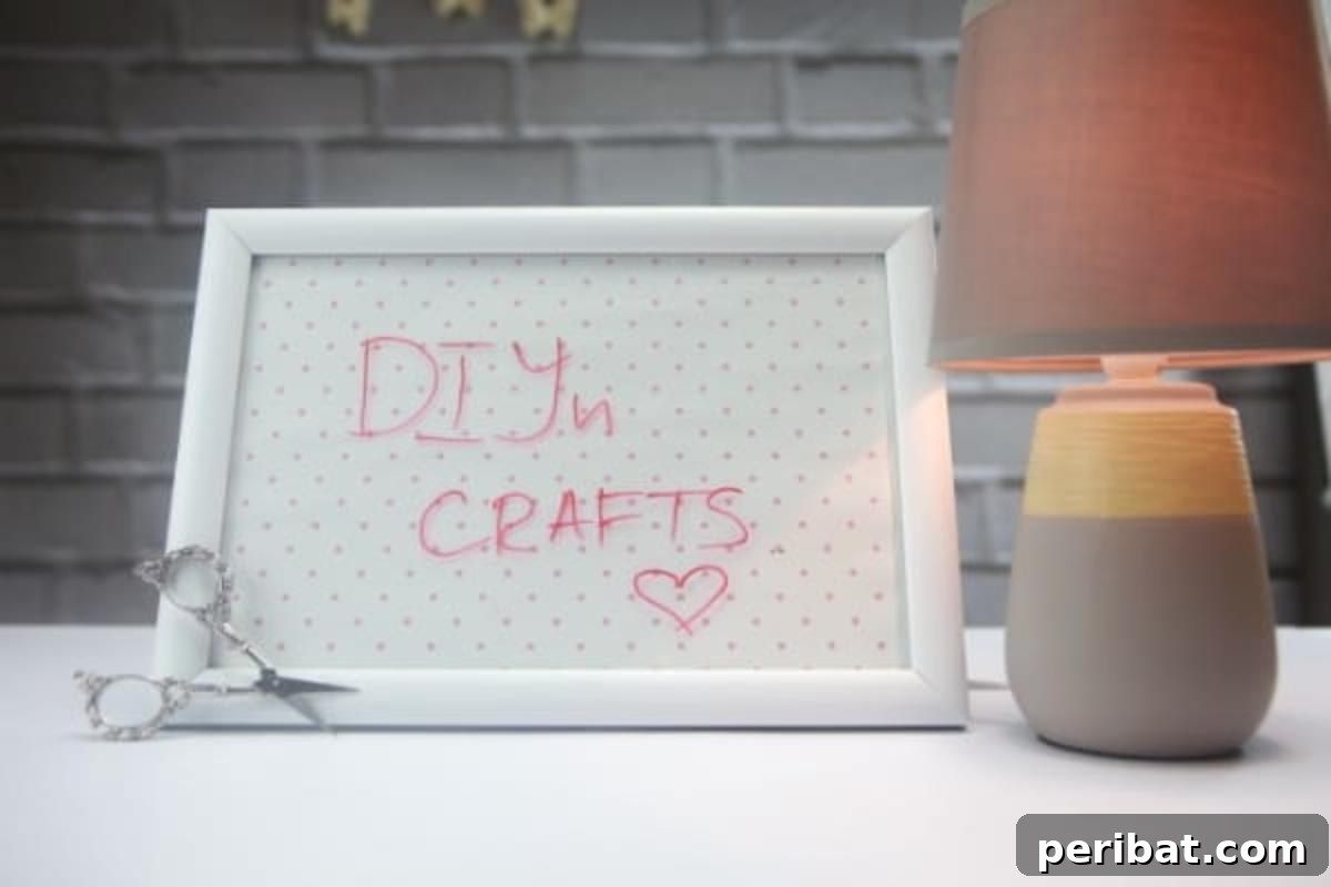 Build a Custom Whiteboard for Your Office 6 A handcrafted whiteboard proudly displays the text “DIYnCrafts,” emphasizing the creative spirit and handmade quality of the project.