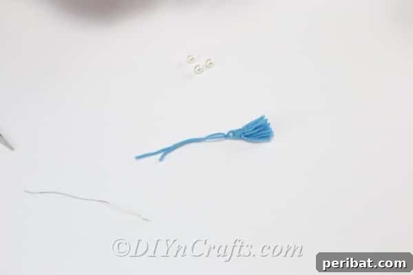 Create Your Own Trendy Yarn Tassel Earrings 10 The tassel appears more refined and complete after tidying the top wrapped section.