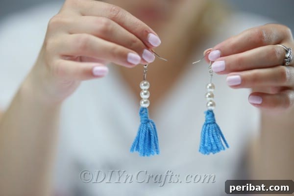 Create Your Own Trendy Yarn Tassel Earrings 15 The completed pair of colorful yarn tassel earrings, showcasing their handmade beauty and readiness for wear.