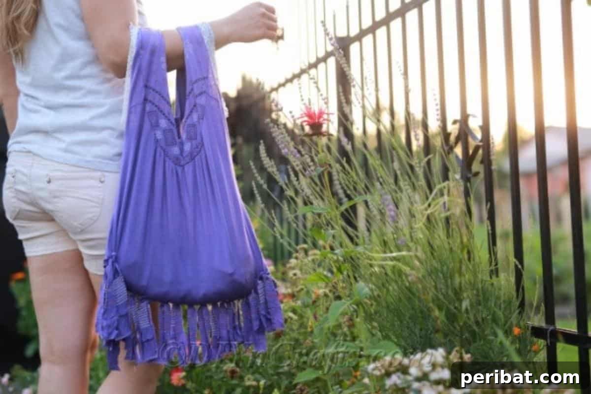 A woman carrying a no-sew T-shirt bag over her arm, demonstrating the ease of the project and its stylish outcome.