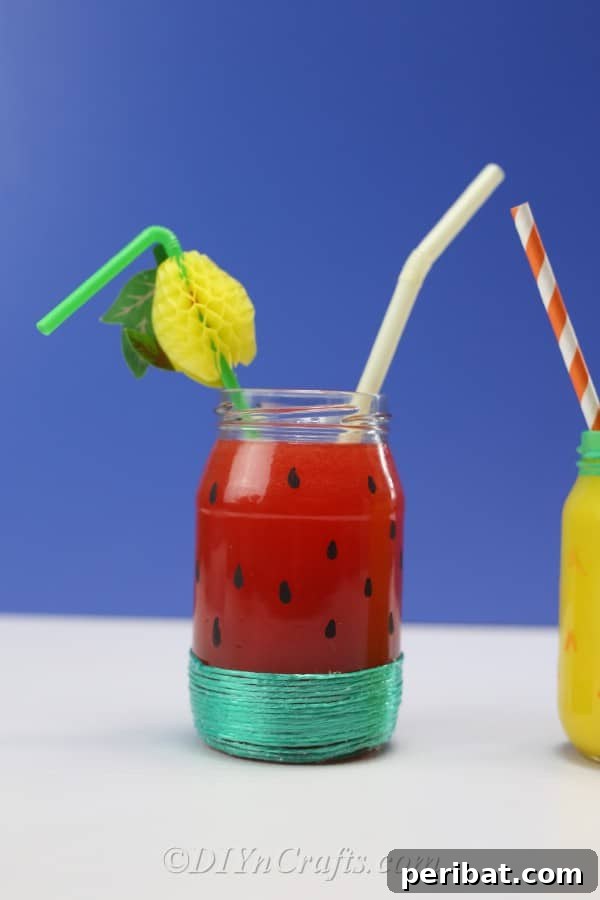 Vibrant Painted Jars for Summer Drinks 16 Refreshing drinks are artfully served in a collection of fruit-painted jars, perfect for a summer celebration.