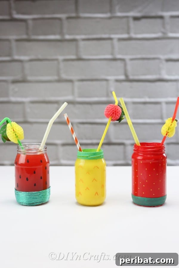 A delightful display of completed fruit-themed jars, each with a straw, ready to brighten any occasion.